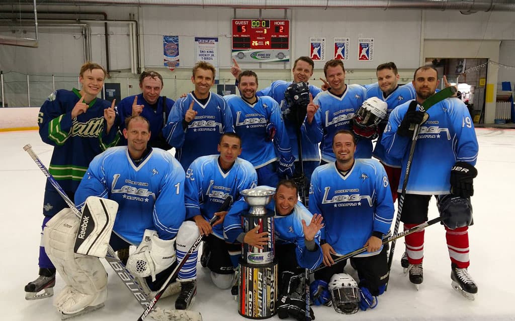 Winning adult hockey team with trophy