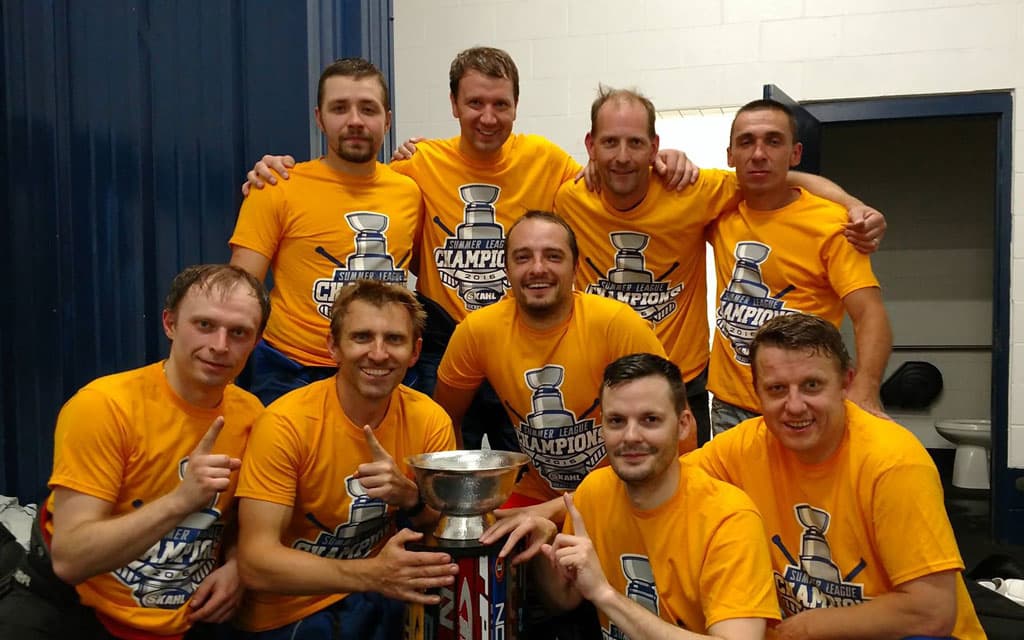 Winning adult hockey team with trophy