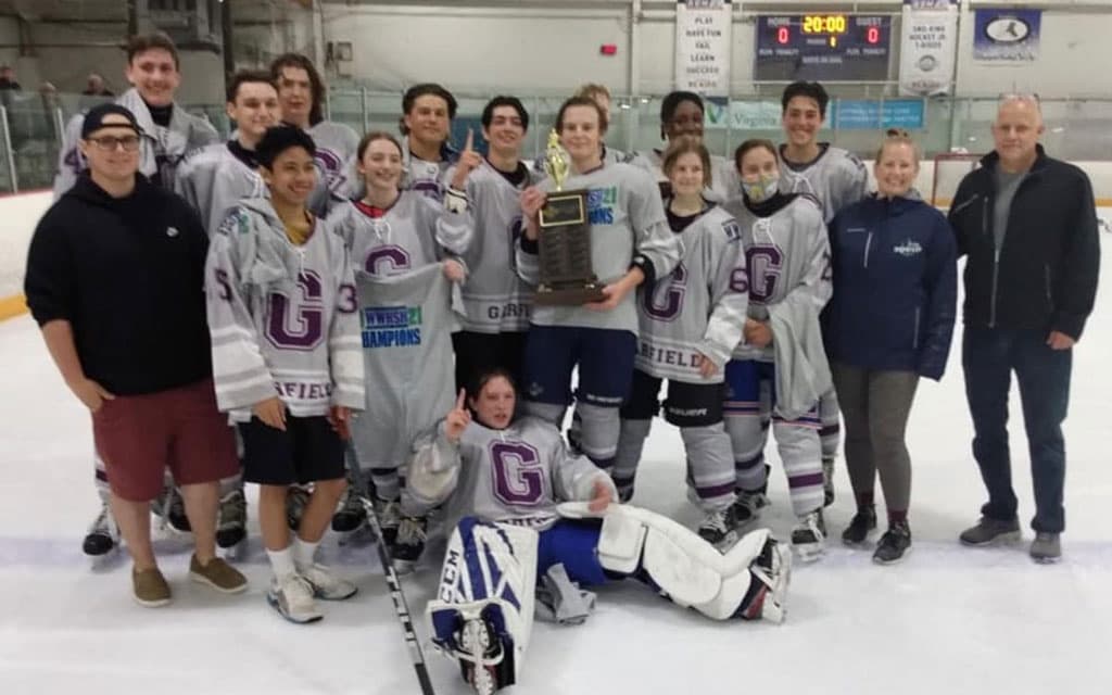 Winning high school hockey team with trophy