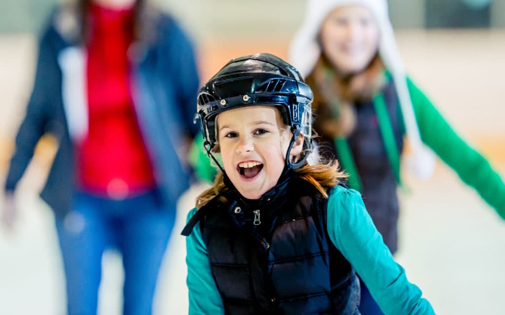 Smiling girl ice skating