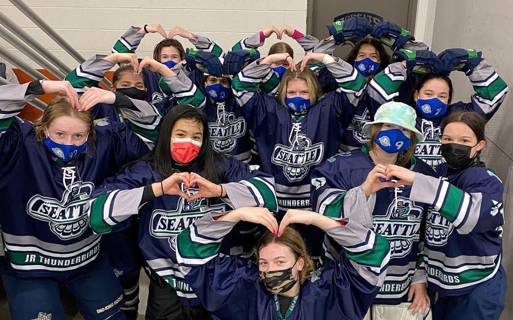 Youth girls hockey team posing for photo