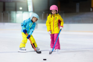Children play ice hockey. Kids winter sport. Learn to hockey skate